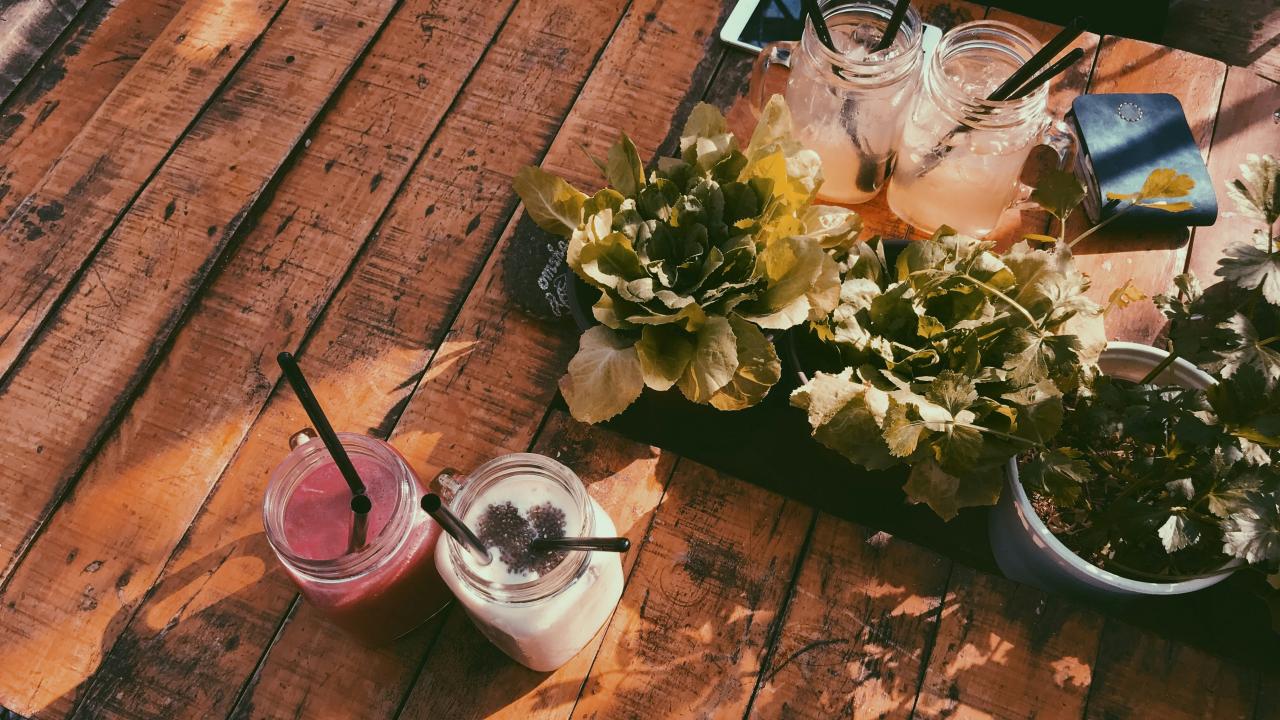 wooden picnic table with drinks