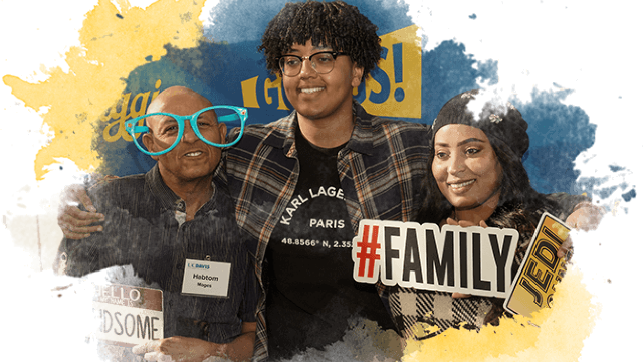 A student stands with their family to pose for a picture at UC Davis Welcome