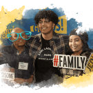 A student stands with their family to pose for a picture at UC Davis Welcome